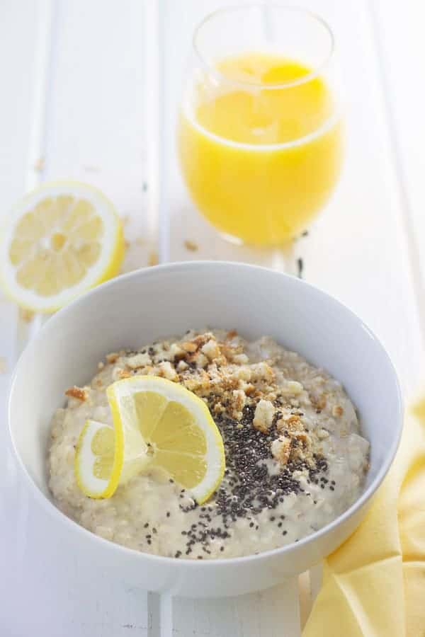 overhead: a bowl of cheesecake overnight oats with lemon, cookies, and chia seeds on top