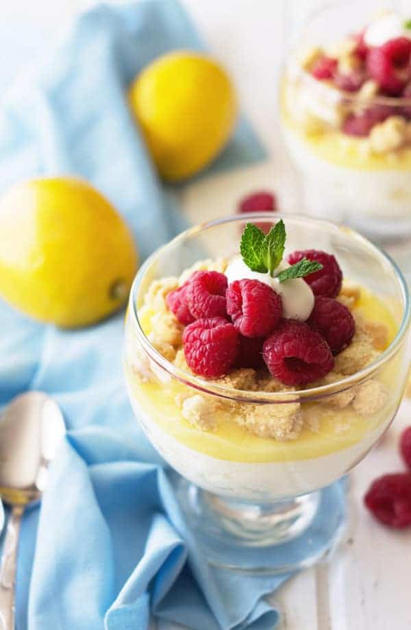 overhead: lemon mousse cup with fresh raspberries on top