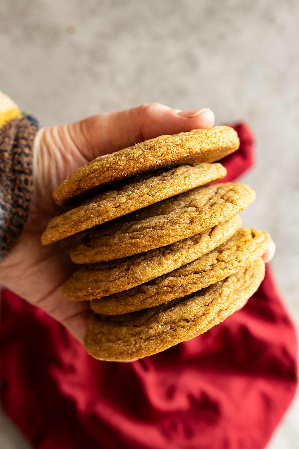 A hand holding a stack of cookies.