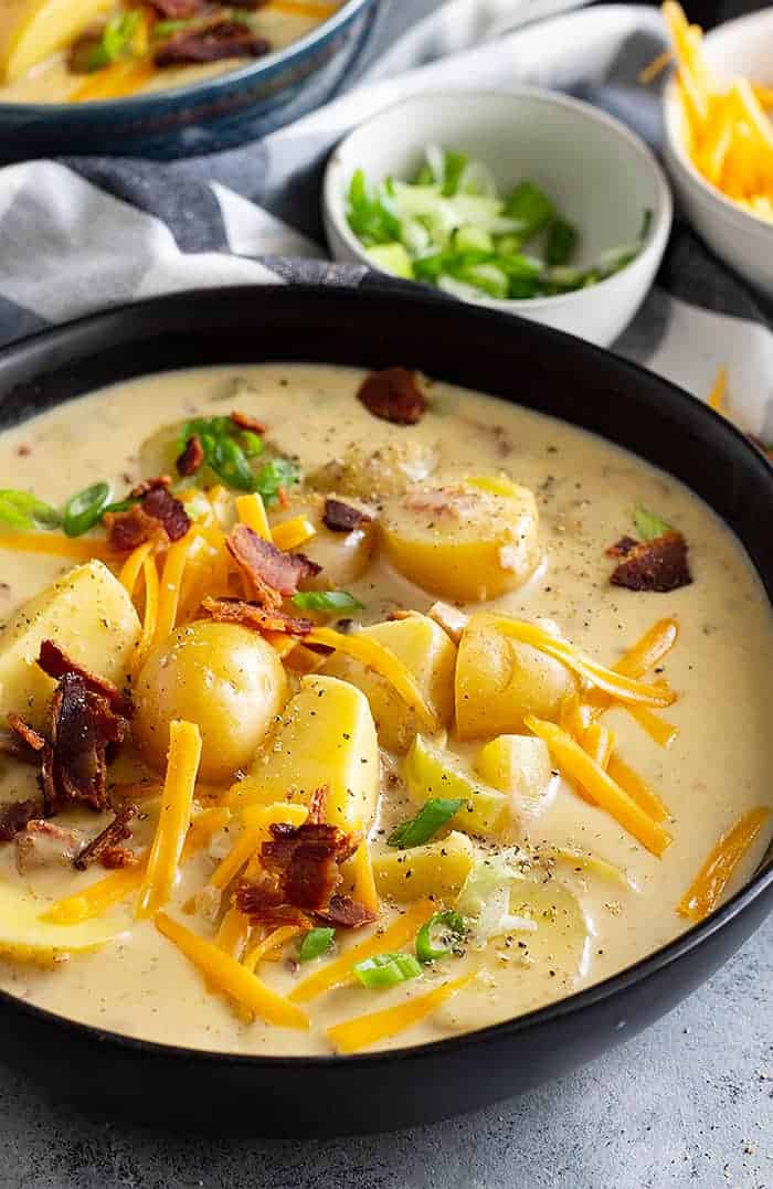overhead: simple potato soup recipe in a bowl with potatoes, bacon, and cheddar cheese on top