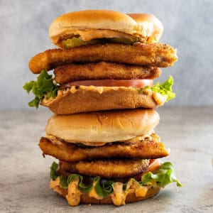 Two chicken sandwiches stacked on top of each other.