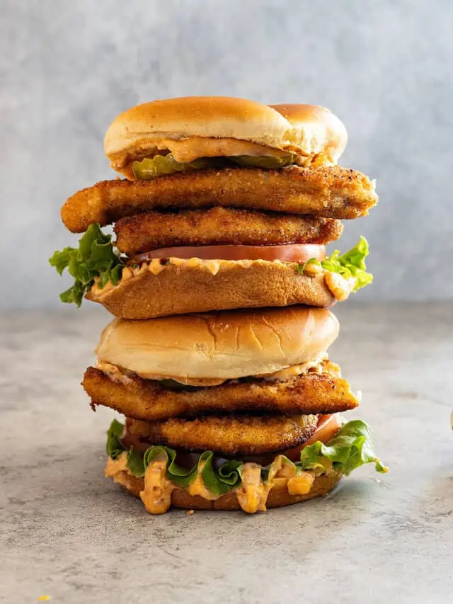 Two chicken sandwiches stacked on top of each other.