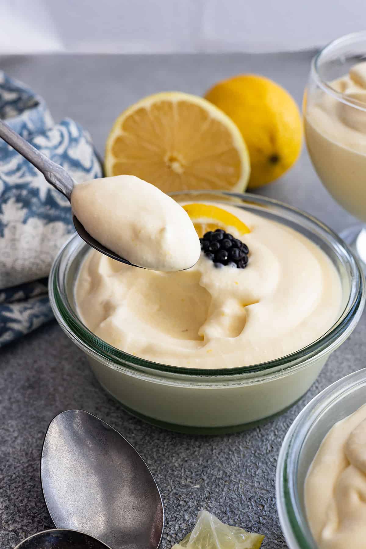 A spoon taking a spoonful of lemon mousse to show how light and fluffy it is. 