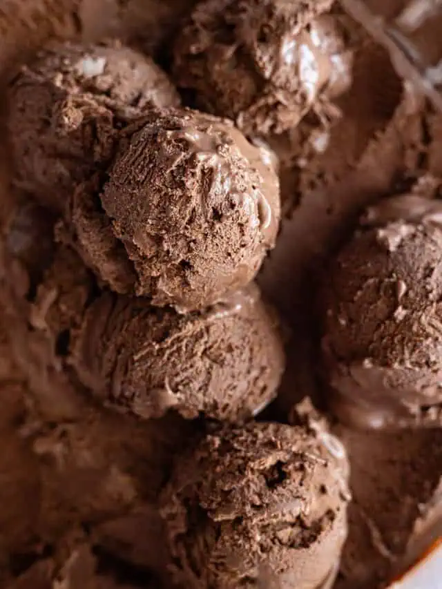 Overhead view of scoops of chocolate ice cream in a container.