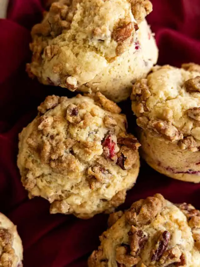 Overhead view of several muffins together on a red napkin.