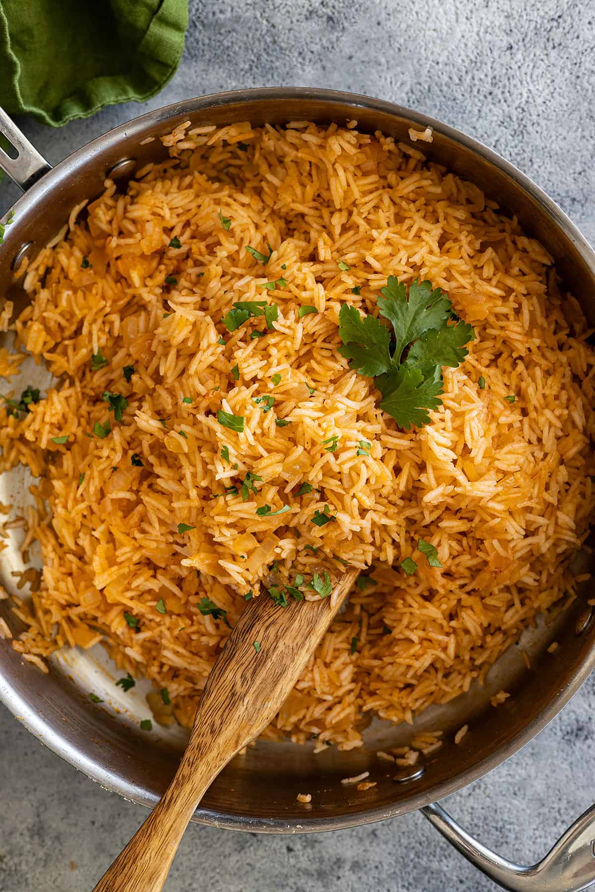 Overhead view of mexican rice in a pan garnished with cilantro.