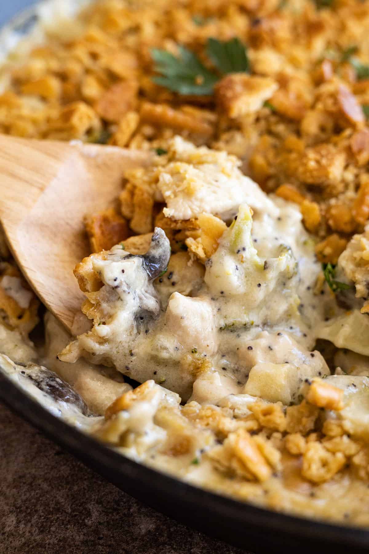 Spoon in casserole showing the creamy inside. 
