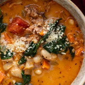 Close up of soup in a bowl with a spoon in it.