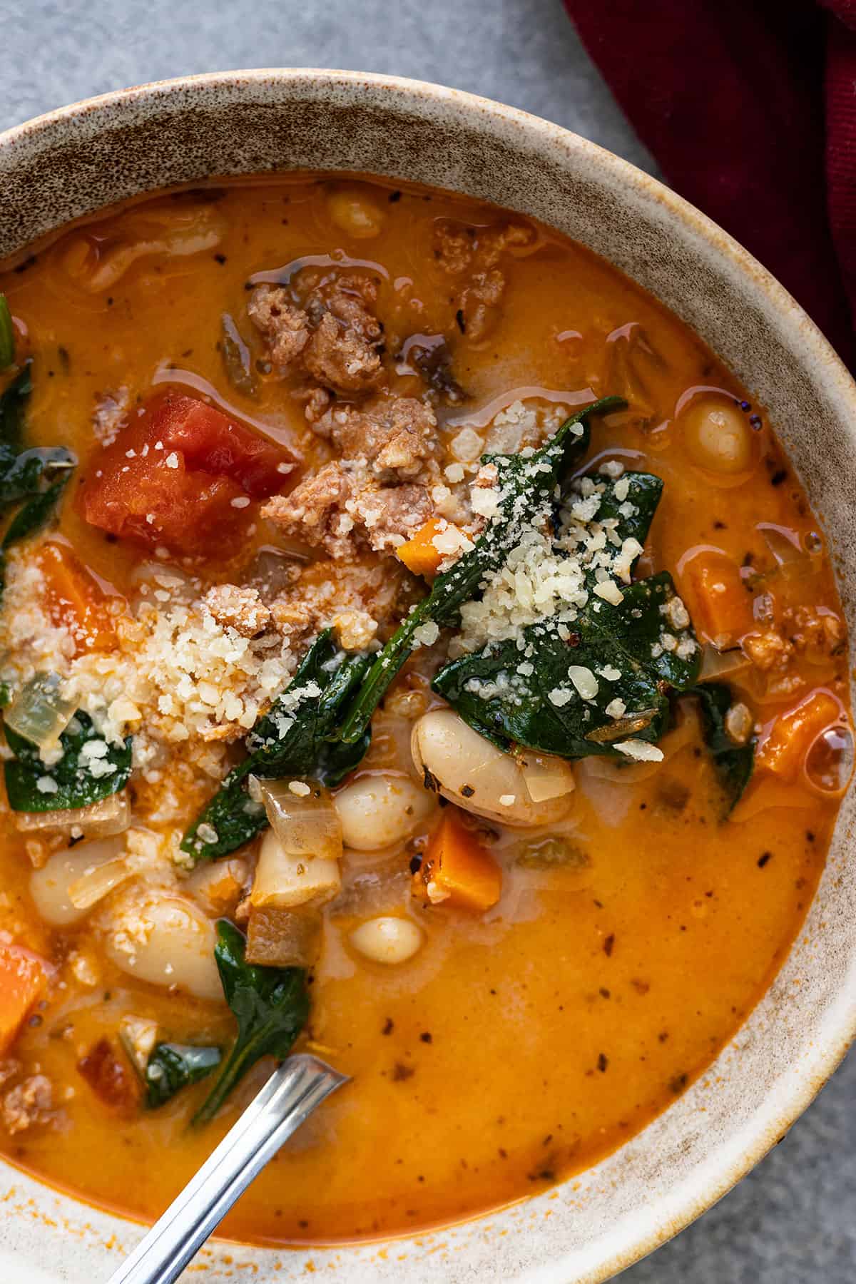 Close up of soup in a bowl with a spoon in it.