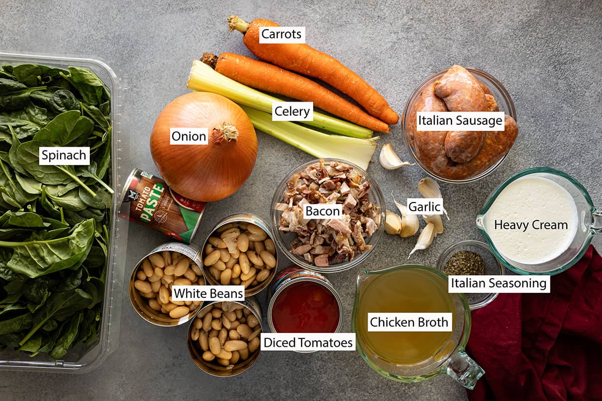 Ingredients: spinach, onion, carrots, celery, tomato paste, Italian sausage, garlic, bacon, cream, Italian seasoning, chicken broth, diced tomatoes, and white beans. 