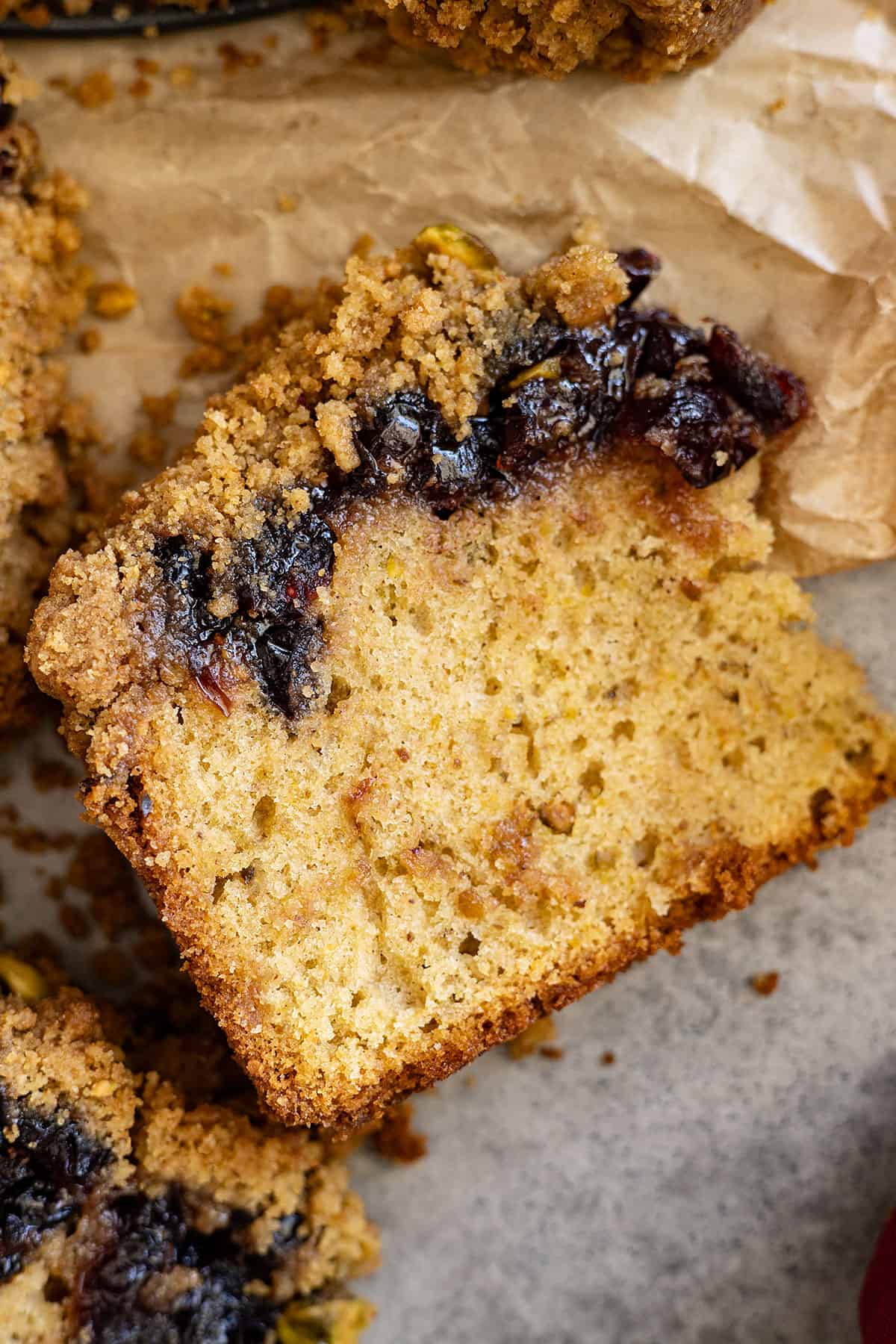 Overhead view of cake slice showing the layer of cranberries.
