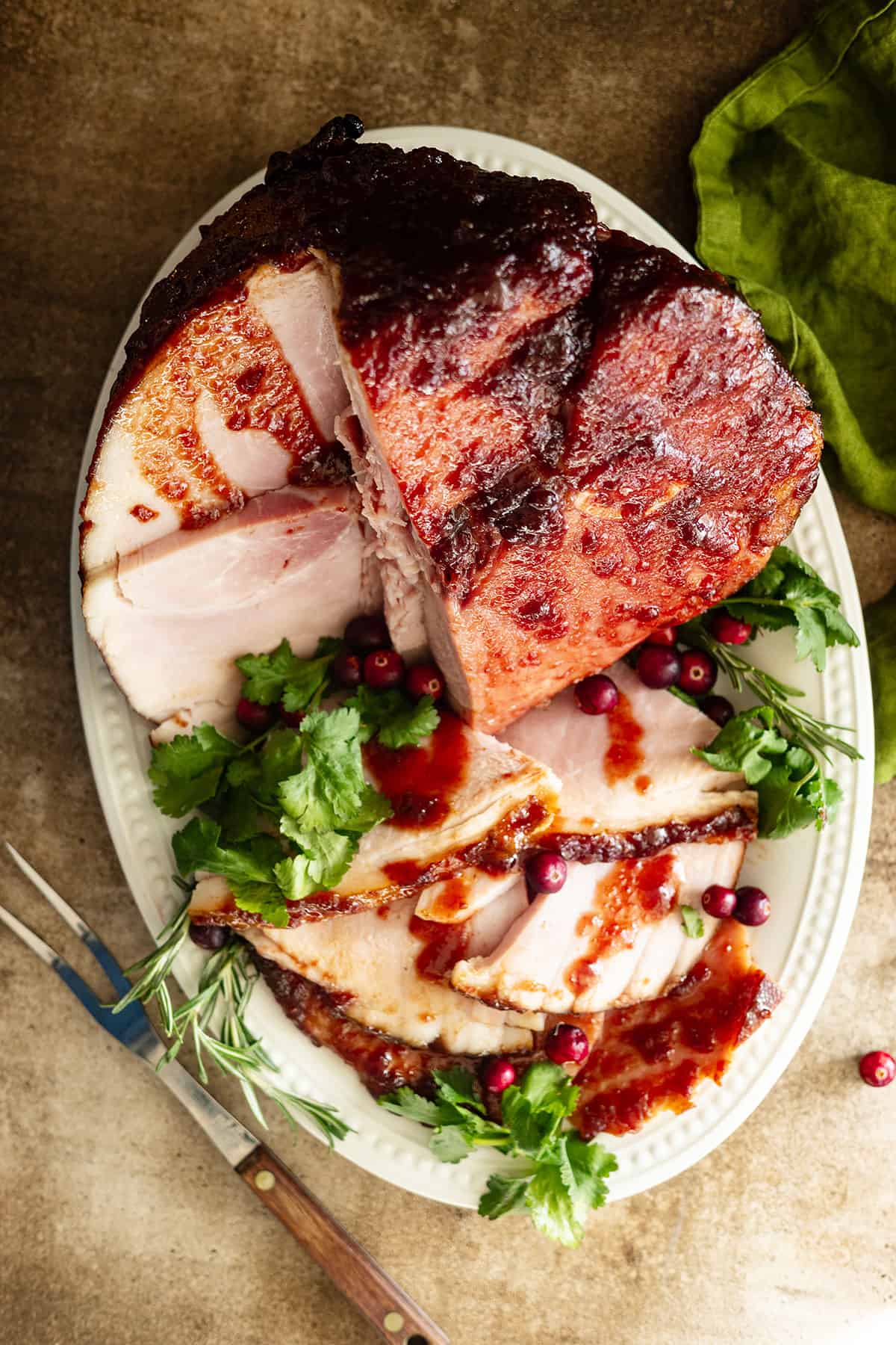 overhead of jalapeno cranberry glazed ham sliced an on a plate.