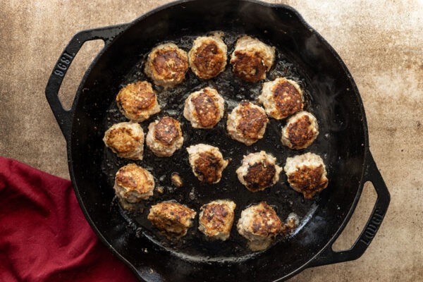 browned turkey meatballs in skillet.