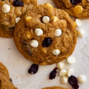 Close up of white chocolate cranberry pumpkin cookies gathered around.