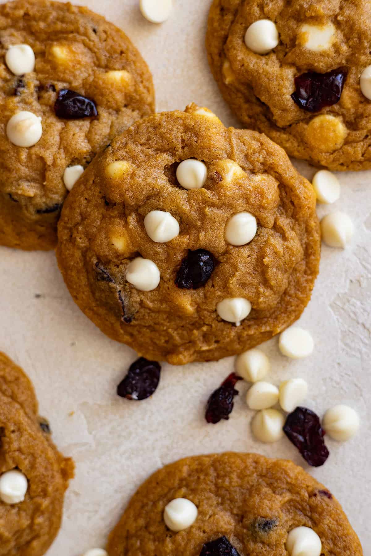 Close up of white chocolate cranberry pumpkin cookies gathered around.