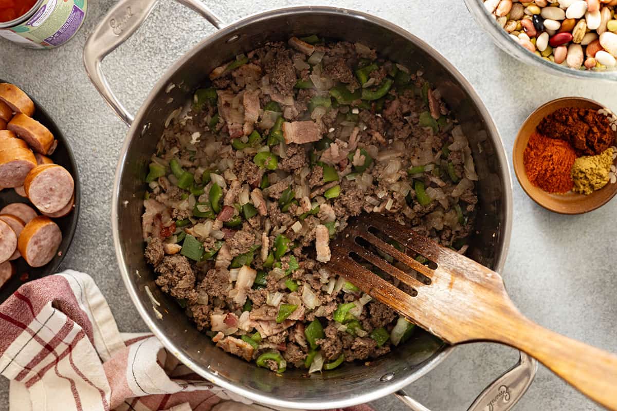 overhead picture of browning ground beef, bacon, and veggies.