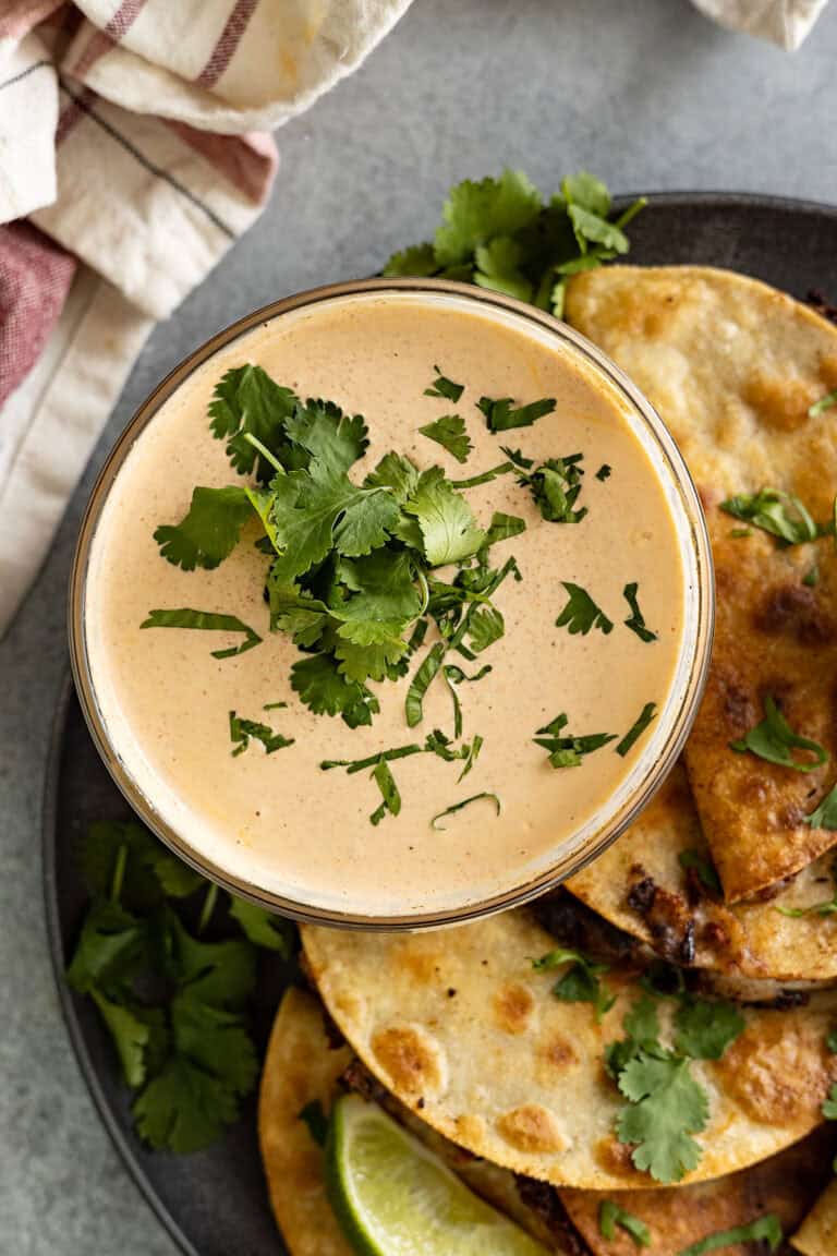Overhead view of creamy taco sauce in a bowl sprinkled with cilantro.