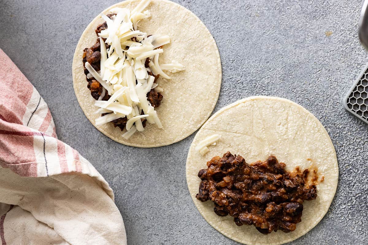 Showing how much filling and cheese to add to the tacos.