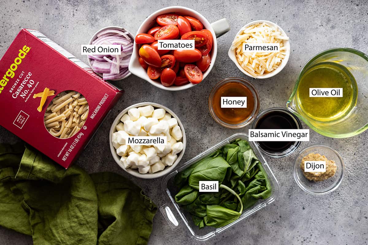 Ingredients: pasta, red onion, tomatoes, parmesan, mozzarella, basil, honey, oil, balsamic vinegar, dijon