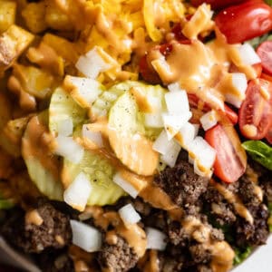 Overhead view of burger bowls drizzled with fry sauce.