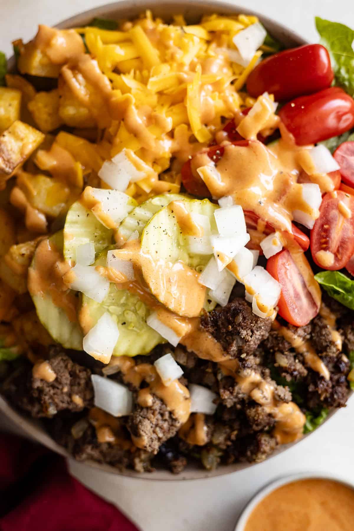 Overhead view of burger bowls drizzled with fry sauce.
