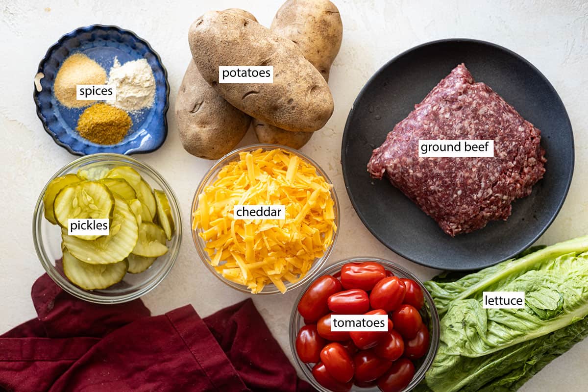 Ingredients: spices, potatoes, ground beef, pickles, cheddar, tomatoes, lettuce.