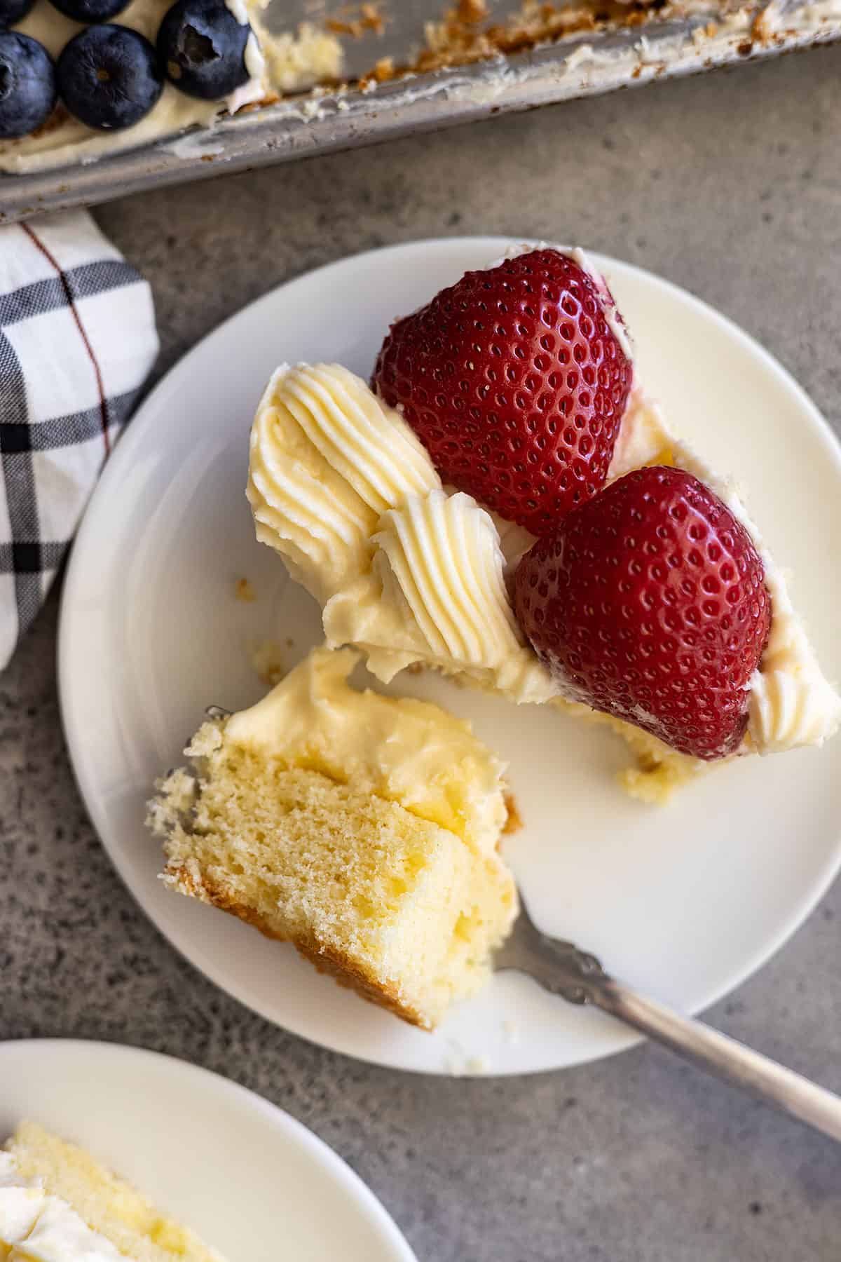 Close up of a bite taken out of the cake to show the fluffy texture of the cake.