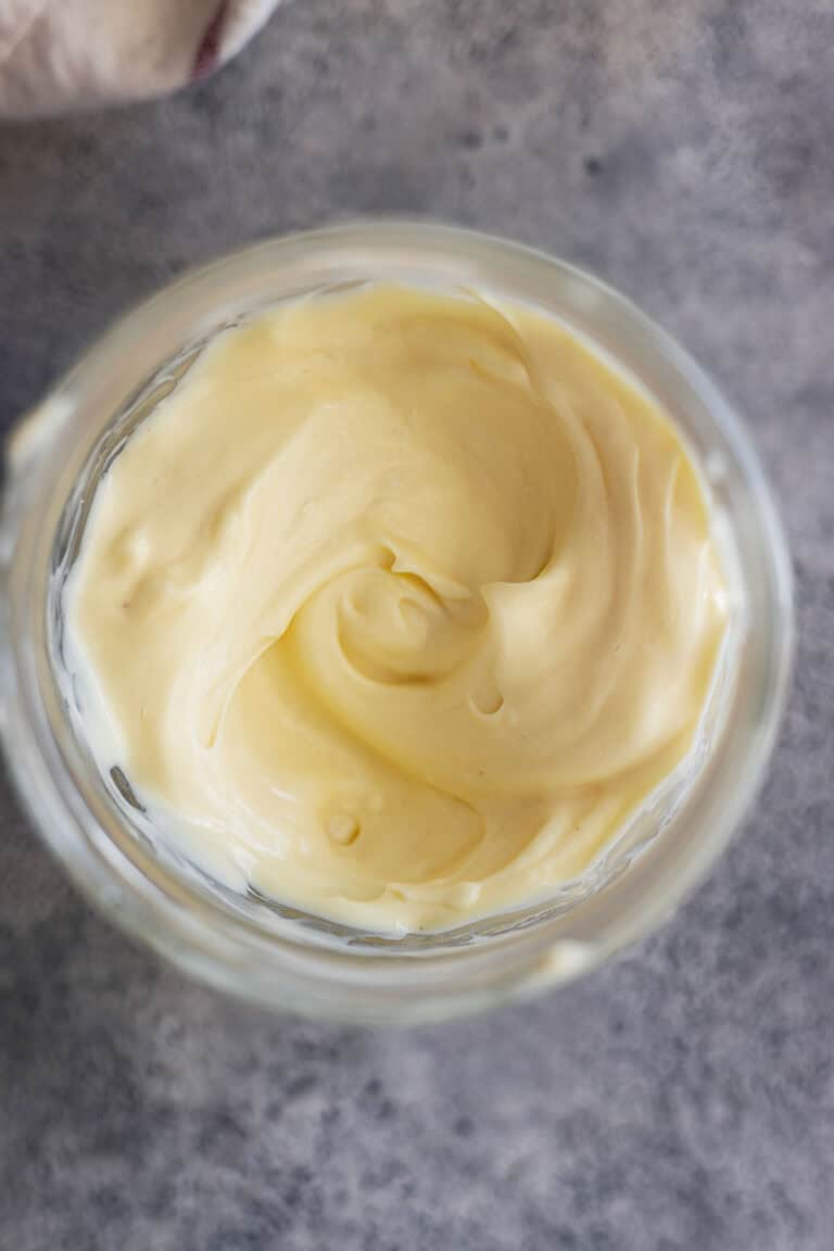 Overhead picture of homemade mayonnaise in a jar.