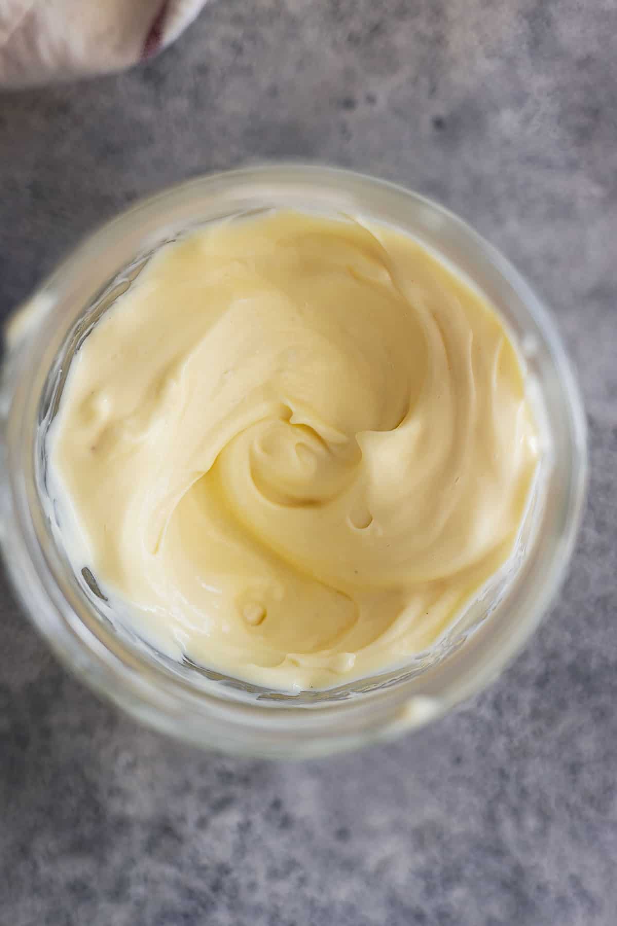 Overhead picture of homemade mayonnaise in a jar.