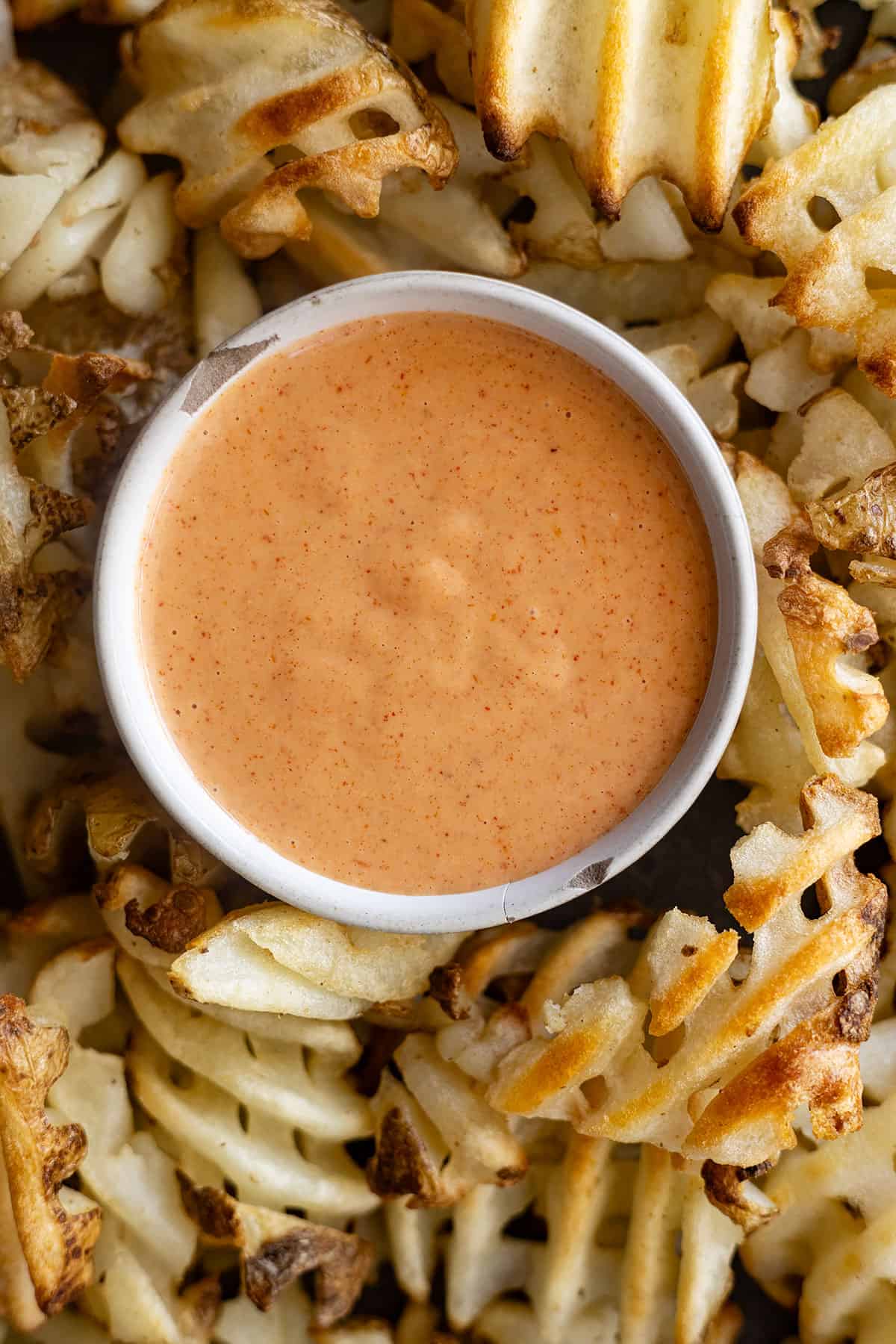 Overhead view of fry sauce in a bowl surrounded by fries.