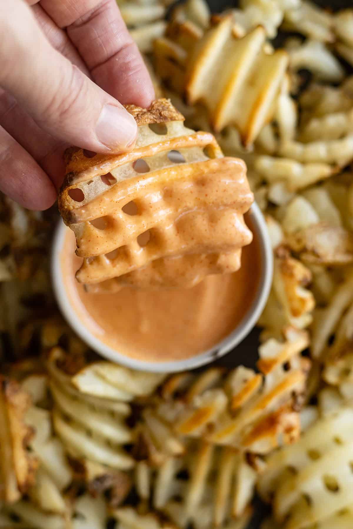 Overhead picture of fry dipping in fry sauce.
