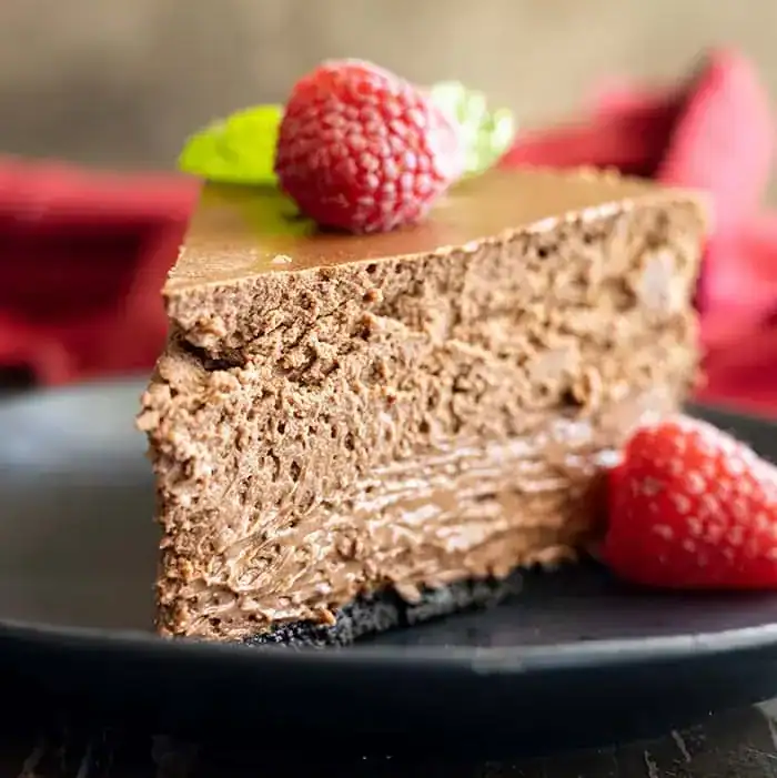 slice of chocolate cheesecake garnished with raspberries