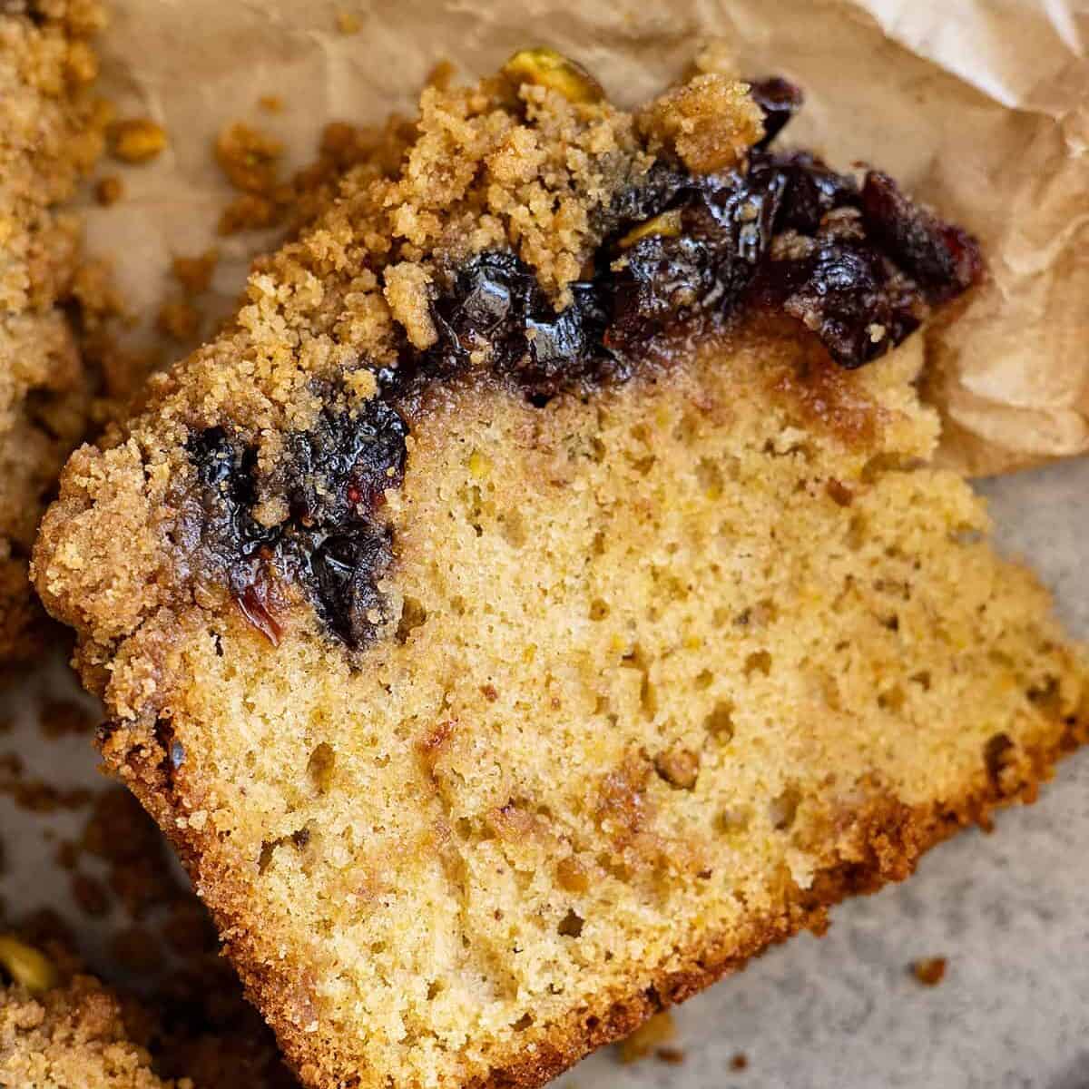 Overhead view of cake slice showing the layer of cranberries.