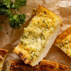 Close up of a slice of garlic bread.