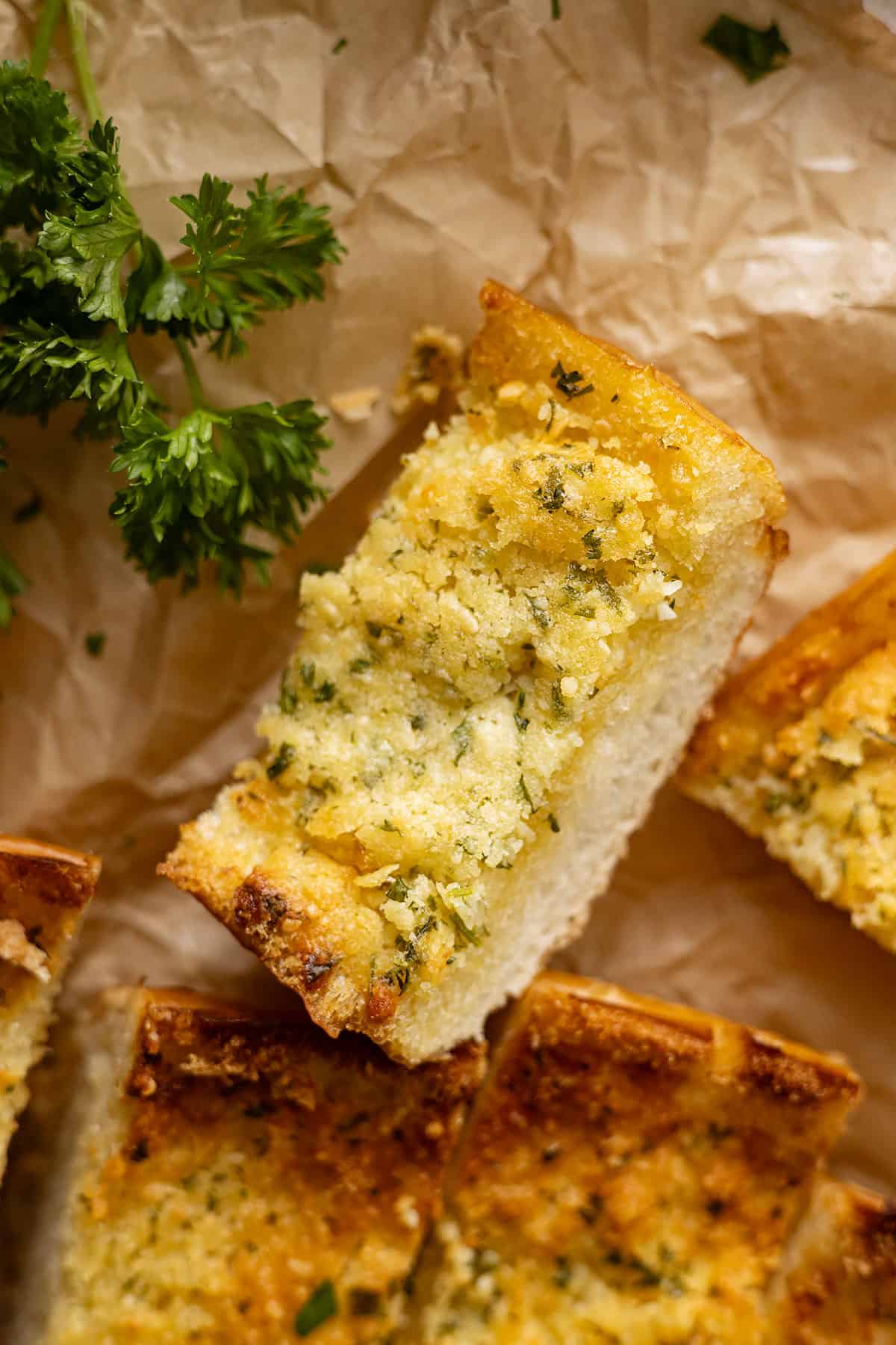 Close up of a slice of garlic bread.