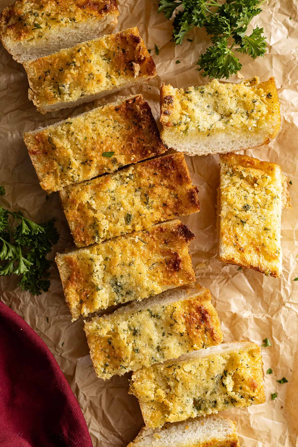 Overhead view of garlic bread cut into pieces ready to serve.