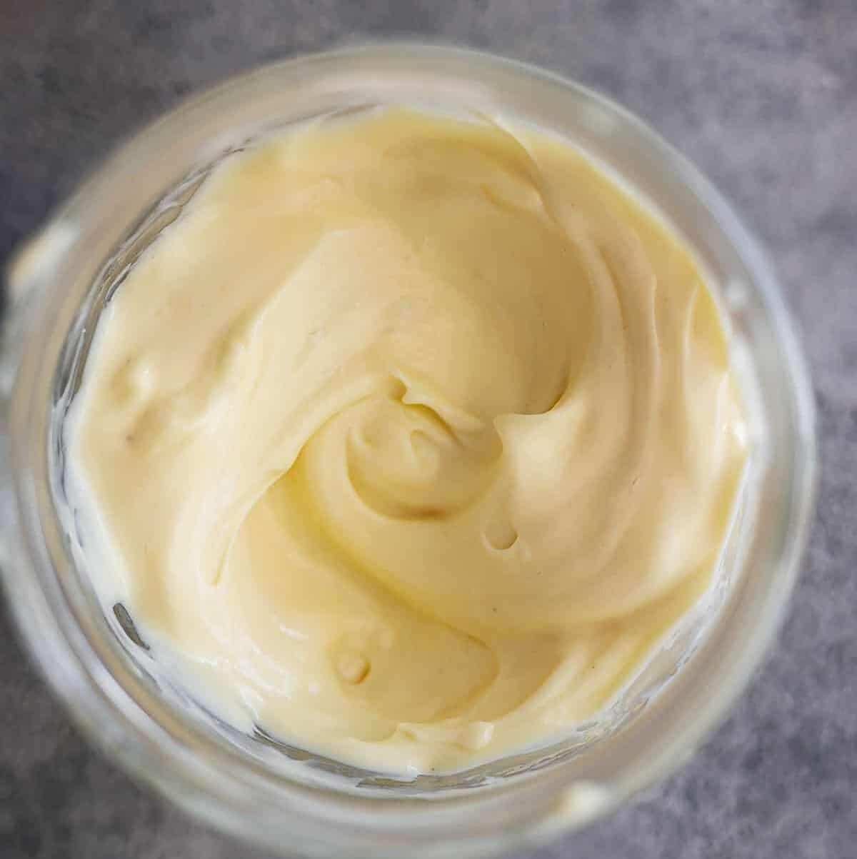 Overhead picture of homemade mayonnaise in a jar.