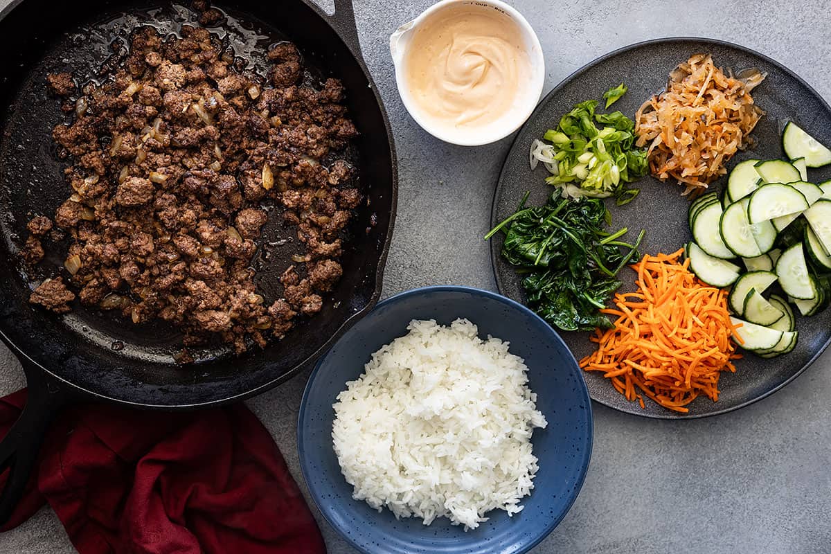 All the components of a Korean ground beef bowl ready to be assembled.