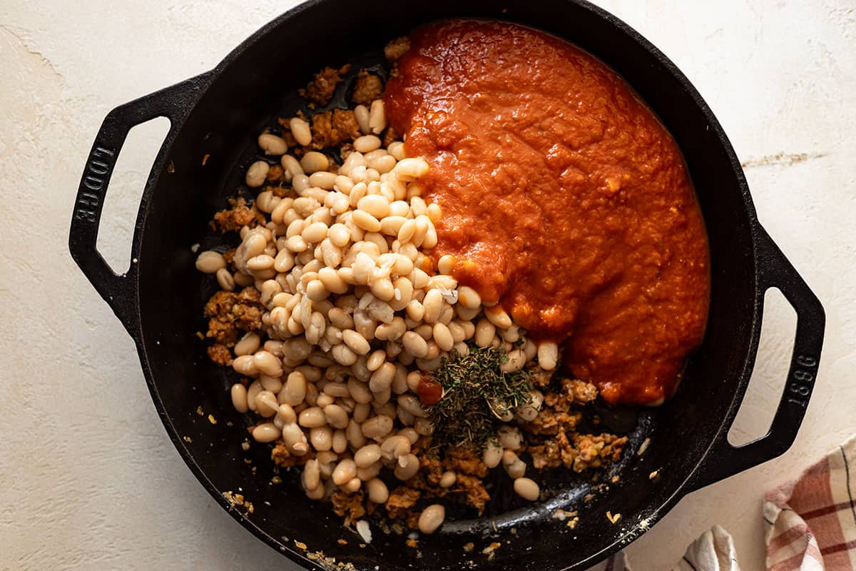 Adding in the beans and pasta sauce.