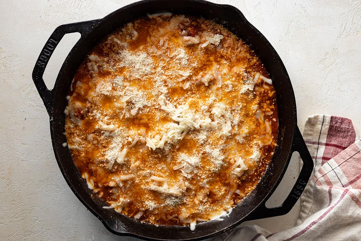Topping with cheese.