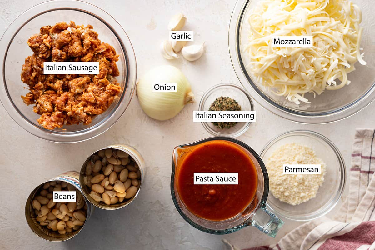 Ingredients: sausage, onion, garlic, pasta sauce, beans, mozzarella, and parmesan cheese.